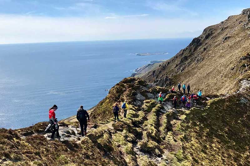 tourists on edge of mountain