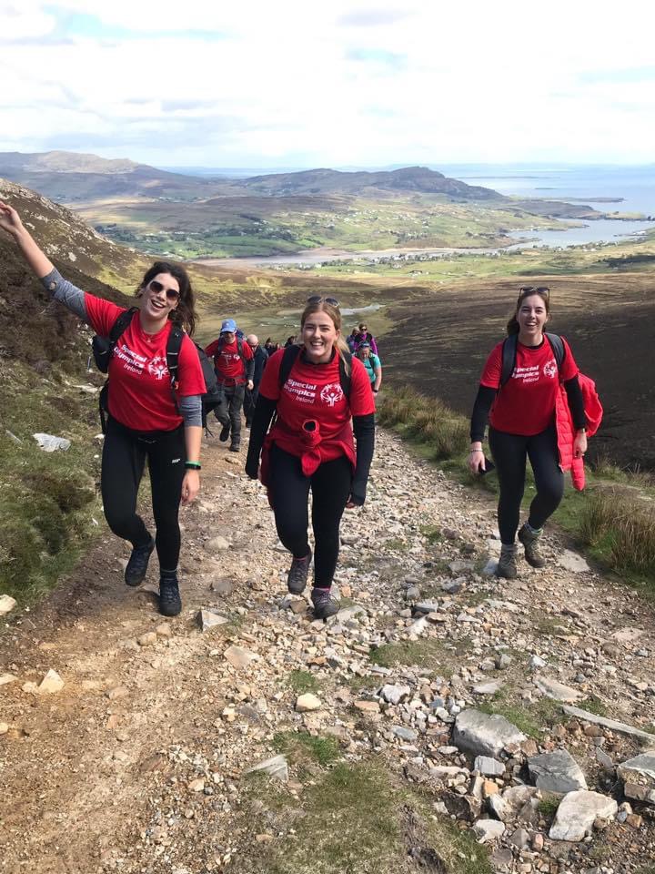 image00016 three friends climbing mountain participating in hiking adventure charity event