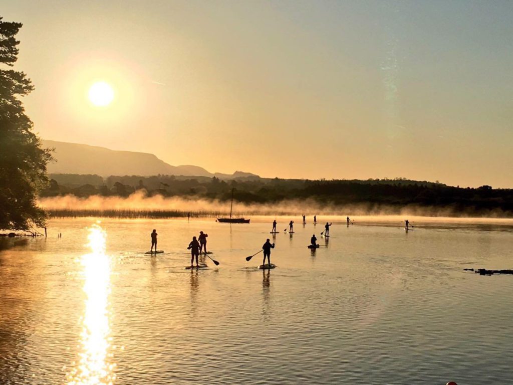 supgaravogue group of people on river doing sup adventure
